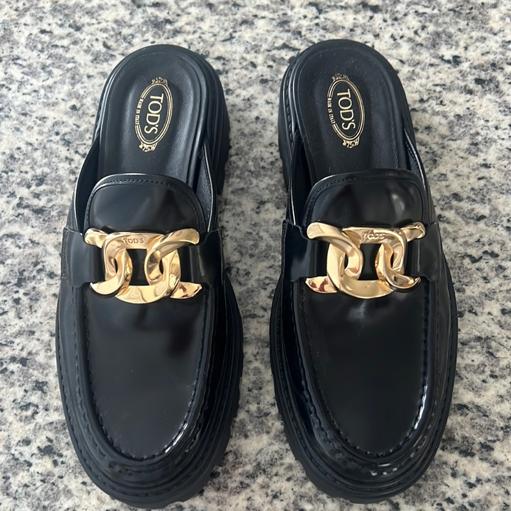 Tod’s black leather and gold mules
